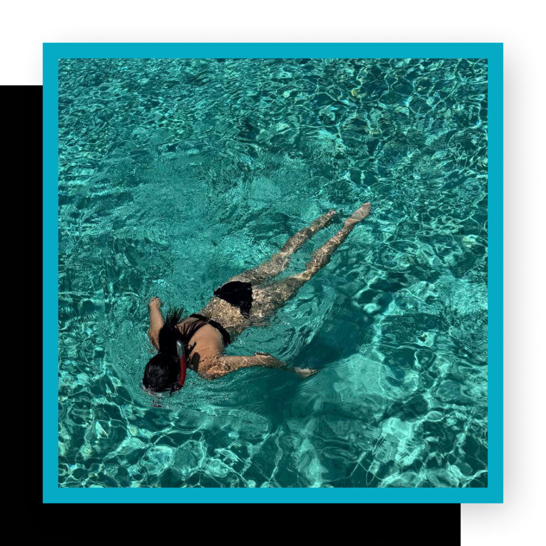 woman snorkeling face-down in water