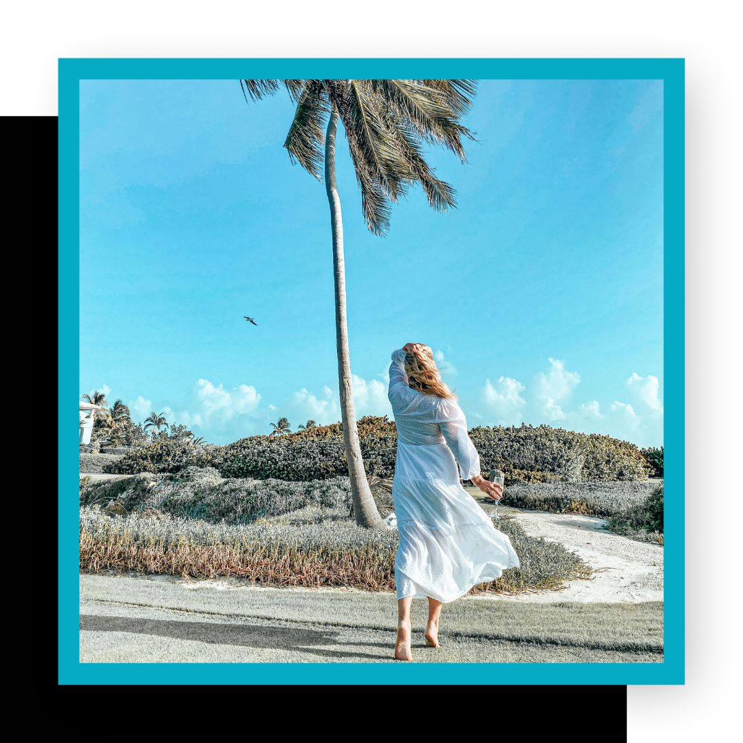 woman in white dress, blowing in wind, palm tree